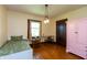 Bright bedroom featuring hardwood floors, natural light, and a charming pink accent cabinet at 4450 N St Rd 39, Danville, IN 46122