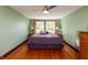 Cozy bedroom with hardwood floors and bright natural light from large windows at 4450 N St Rd 39, Danville, IN 46122