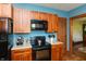 Kitchen showcasing a stove, microwave, cabinets, and an open doorway at 4450 N St Rd 39, Danville, IN 46122
