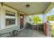 Relaxing covered front porch with small table, chairs, stone detail and outdoor decor at 4450 N St Rd 39, Danville, IN 46122