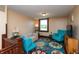 Cozy sitting area with two turquoise chairs, patterned rug, and natural light at 4450 N St Rd 39, Danville, IN 46122
