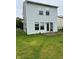 Back exterior of the house with a sliding glass door leading to the backyard and a small wooden deck at 4456 Redcliff N Ln, Plainfield, IN 46168
