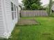 Side view of a backyard featuring a small wooden deck, grass, and fencing at 4456 Redcliff N Ln, Plainfield, IN 46168