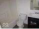 A bathroom featuring a tub, toilet, vanity, sink, and neutral colors at 4456 Redcliff N Ln, Plainfield, IN 46168