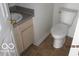 Compact bathroom featuring a toilet, a sink with vanity, and tile flooring at 4456 Redcliff N Ln, Plainfield, IN 46168