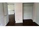 A pink bedroom featuring hardwood floors, closet space, and neutral trim at 4456 Redcliff N Ln, Plainfield, IN 46168