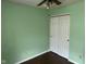 A light green bedroom with hardwood floors, a ceiling fan, and a closet at 4456 Redcliff N Ln, Plainfield, IN 46168