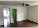 Bright living room featuring hardwood floors, neutral walls, ceiling fan, and open doorway to adjacent rooms at 4456 Redcliff N Ln, Plainfield, IN 46168