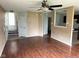 Spacious living room featuring wood floors, an open layout, and access to the kitchen and stairway at 4456 Redcliff N Ln, Plainfield, IN 46168
