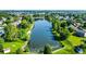 Overhead perspective of a tranquil pond nestled within a residential area, showcasing lush trees and manicured lawns at 4506 Tarragon Dr, Indianapolis, IN 46237