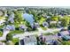 Scenic aerial view of a suburban neighborhood with a tranquil pond surrounded by lush greenery and well-maintained homes at 4506 Tarragon Dr, Indianapolis, IN 46237