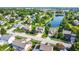 Scenic aerial view of a suburban neighborhood with a tranquil pond surrounded by lush greenery and well-maintained homes at 4506 Tarragon Dr, Indianapolis, IN 46237