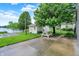 A serene backyard features a shed, patio, and picnic table, with a view of the lake at 4506 Tarragon Dr, Indianapolis, IN 46237