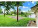 Large backyard with a basketball court and climbing structure, framed by mature trees and green grass at 4506 Tarragon Dr, Indianapolis, IN 46237
