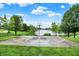 Outdoor basketball court with a water view, bordered by lush greenery and partially enclosed by a chain-link fence at 4506 Tarragon Dr, Indianapolis, IN 46237