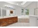 Bright bathroom with double sink vanity, soaking tub and lots of natural light at 4506 Tarragon Dr, Indianapolis, IN 46237