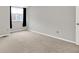 Bedroom with beige carpeting, neutral walls, and window with black curtains at 4506 Tarragon Dr, Indianapolis, IN 46237