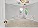 Bedroom with neutral carpet, ceiling fan, and large windows providing natural light at 4506 Tarragon Dr, Indianapolis, IN 46237