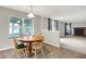 Dining area offering a view of the lake, outdoor seating, and the living room fireplace at 4506 Tarragon Dr, Indianapolis, IN 46237
