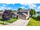 Charming two-story home with a brick facade, attached garage, landscaped yard, and proximity to a serene lake at 4506 Tarragon Dr, Indianapolis, IN 46237