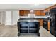 Well-lit kitchen featuring wood cabinets, dark countertops, stainless steel appliances, and a center island for extra space at 4506 Tarragon Dr, Indianapolis, IN 46237