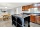 A bright kitchen with dark countertops, wood cabinets, stainless steel appliances, and a center island with storage at 4506 Tarragon Dr, Indianapolis, IN 46237