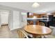 Bright kitchen features wood cabinets, black appliances, an island, and an adjacent dining area with a wooden table at 4506 Tarragon Dr, Indianapolis, IN 46237