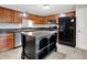 The bright kitchen features wooden cabinets, dark countertops, an island with storage, and stainless steel appliances at 4506 Tarragon Dr, Indianapolis, IN 46237