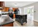 The kitchen features dark cabinets, an island with storage, and modern appliances with easy access to other rooms at 4506 Tarragon Dr, Indianapolis, IN 46237