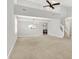 Spacious open-concept living room featuring a high ceiling, a chandelier, and neutral carpet at 4506 Tarragon Dr, Indianapolis, IN 46237