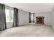 Spacious living room with neutral carpet, fireplace, and large windows with decorative curtains for bright natural light at 4506 Tarragon Dr, Indianapolis, IN 46237