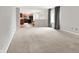 Open living space with easy access to the kitchen featuring neutral-colored walls and carpet for a bright atmosphere at 4506 Tarragon Dr, Indianapolis, IN 46237