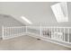 Bright loft area with skylights, railing, and neutral carpeting at 4506 Tarragon Dr, Indianapolis, IN 46237