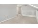 Loft area featuring neutral carpeting, railing, and access to multiple rooms at 4506 Tarragon Dr, Indianapolis, IN 46237