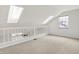 Bright loft area with skylights, railing, and neutral carpeting at 4506 Tarragon Dr, Indianapolis, IN 46237