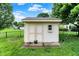 Outdoor storage shed with double doors and a window, situated on a well-maintained lawn at 4506 Tarragon Dr, Indianapolis, IN 46237