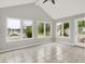 Sunroom featuring tile flooring and large windows overlooking a scenic water view at 4506 Tarragon Dr, Indianapolis, IN 46237