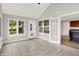 Bright sunroom with tile flooring, large windows, and a door leading to the outside at 4506 Tarragon Dr, Indianapolis, IN 46237