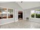 Sunroom with a bright, open design, featuring tile floors and access to the kitchen, and large windows at 4506 Tarragon Dr, Indianapolis, IN 46237