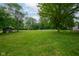 Expansive backyard with mature shade trees, chicken coop and lots of green space at 5160 N High School Rd, Indianapolis, IN 46254