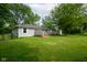 Well-maintained backyard with a deck, a fenced area and lush lawn at 5160 N High School Rd, Indianapolis, IN 46254