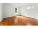 Bright bedroom features hardwood floors and two windows providing plenty of natural light at 5160 N High School Rd, Indianapolis, IN 46254