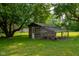 Backyard chicken coop with covered run and mature trees at 5160 N High School Rd, Indianapolis, IN 46254