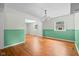 Open dining room featuring hardwood floors, updated chandelier, and fresh paint at 5160 N High School Rd, Indianapolis, IN 46254