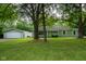Charming single-story home with a well-manicured lawn, mature trees, and a welcoming front porch at 5160 N High School Rd, Indianapolis, IN 46254