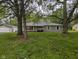 Charming single-story home with a detached garage and a beautiful, spacious front yard featuring mature trees at 5160 N High School Rd, Indianapolis, IN 46254