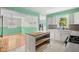 Modern kitchen featuring white cabinets, stainless steel appliances, and a central island for meal preparation at 5160 N High School Rd, Indianapolis, IN 46254