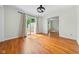 Hardwood floors flow throughout this living room with modern ceiling fan and sliding glass door at 5160 N High School Rd, Indianapolis, IN 46254