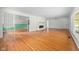 Open-concept living area featuring hardwood floors, a decorative fireplace, and seamless flow to other rooms at 5160 N High School Rd, Indianapolis, IN 46254