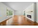 Spacious living room with hardwood floors, large windows, and a stylish fireplace for a cozy atmosphere at 5160 N High School Rd, Indianapolis, IN 46254